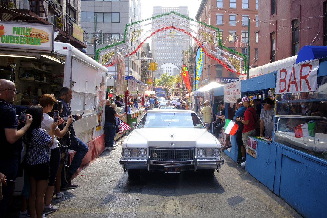A car rides up Mulberry Street during the procession.
